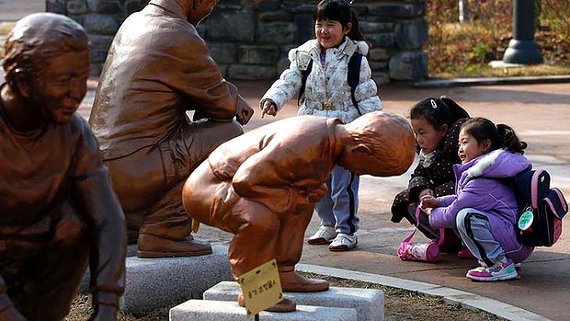 squatting bronze figures